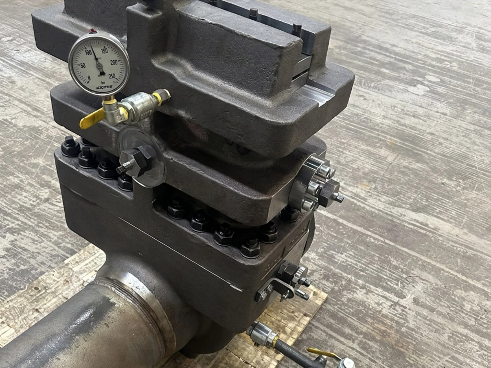 Dual chamber orifice fitting on its meter spool under pressure test, gauge mounted on the body