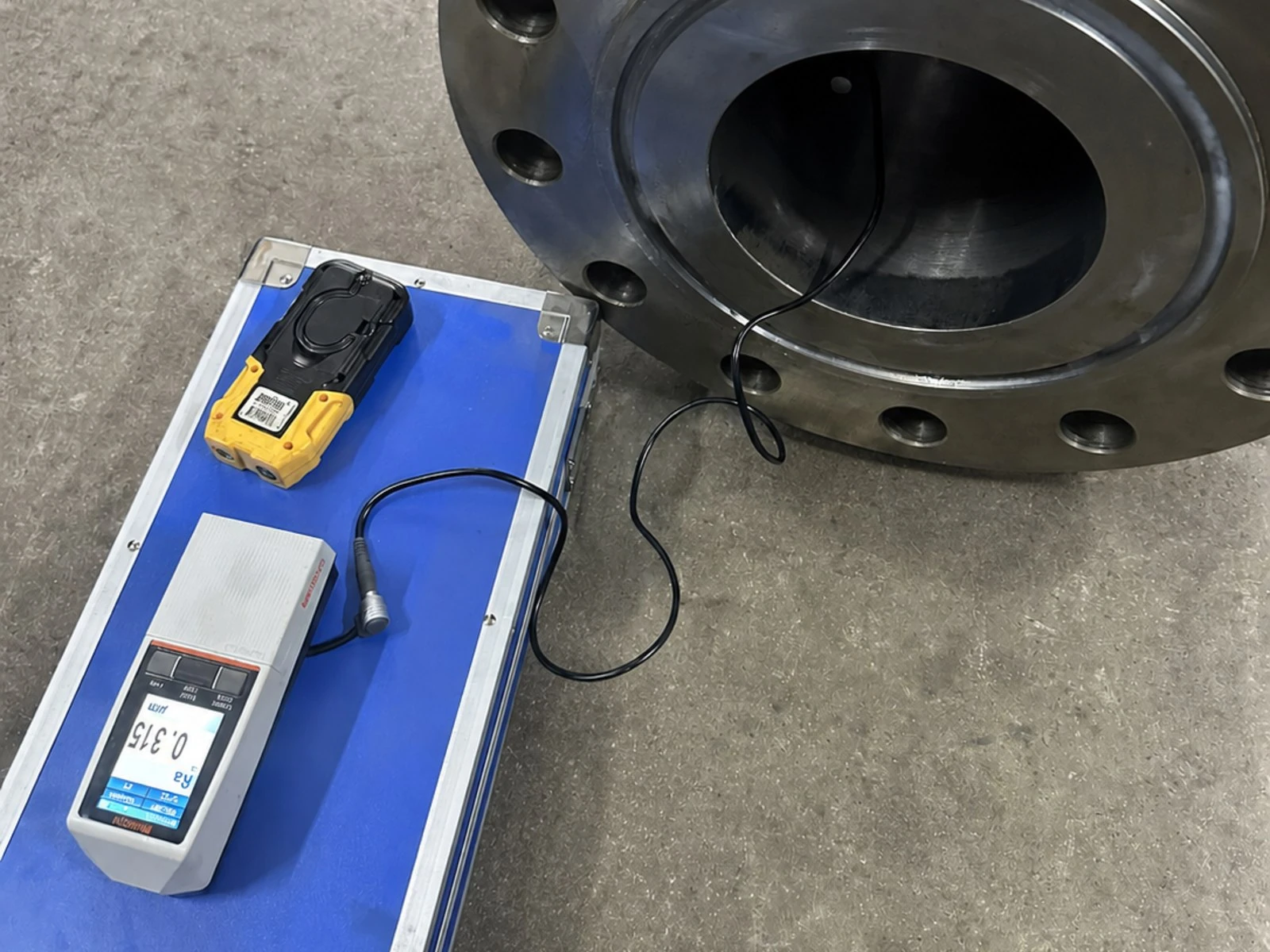 Surface roughness of a machined meter tube bore measured with a portable tester, reading Ra 0.315 micrometre
