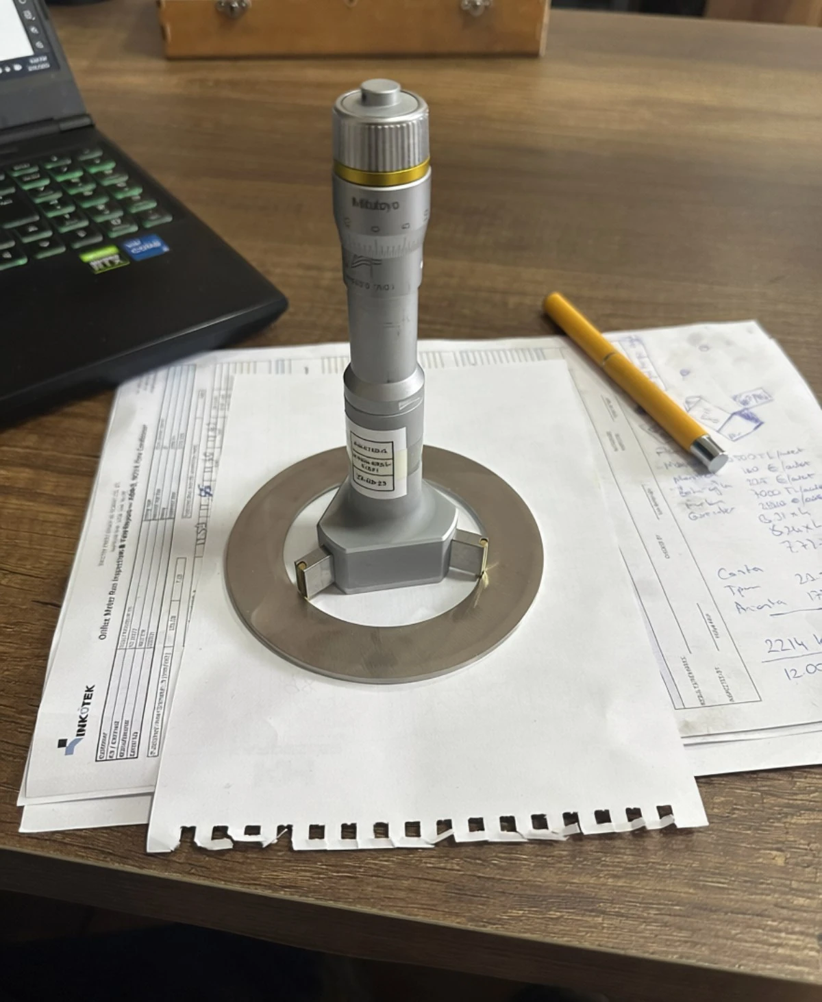 Orifice bore measured with a three-point internal micrometer against the inspection report