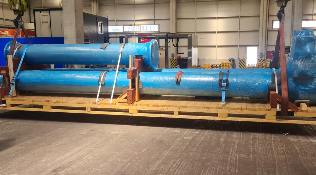 Wrapped meter spools cradled and lashed on a timber skid for shipment