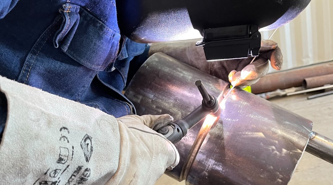TIG welding a nozzle joint, arc and filler rod at the weld pool